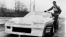 A half length portrait of racing driver Willy T Ribbs, a member of the Budweiser Trans Am team, standing next to his racing car, 1980. (Photo by Afro American Newspapers/Gado/Getty Images)