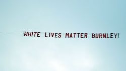 TOPSHOT - A banner reading 'White Lives Matter Burnley' is towed by a plane above the stadium during the English Premier League football match between Manchester City and Burnley at the Etihad Stadium in Manchester, north west England, on June 22, 2020. (Photo by Shaun Botterill / POOL / AFP) / RESTRICTED TO EDITORIAL USE. No use with unauthorized audio, video, data, fixture lists, club/league logos or 'live' services. Online in-match use limited to 120 images. An additional 40 images may be used in extra time. No video emulation. Social media in-match use limited to 120 images. An additional 40 images may be used in extra time. No use in betting publications, games or single club/league/player publications. /  (Photo by SHAUN BOTTERILL/POOL/AFP via Getty Images)