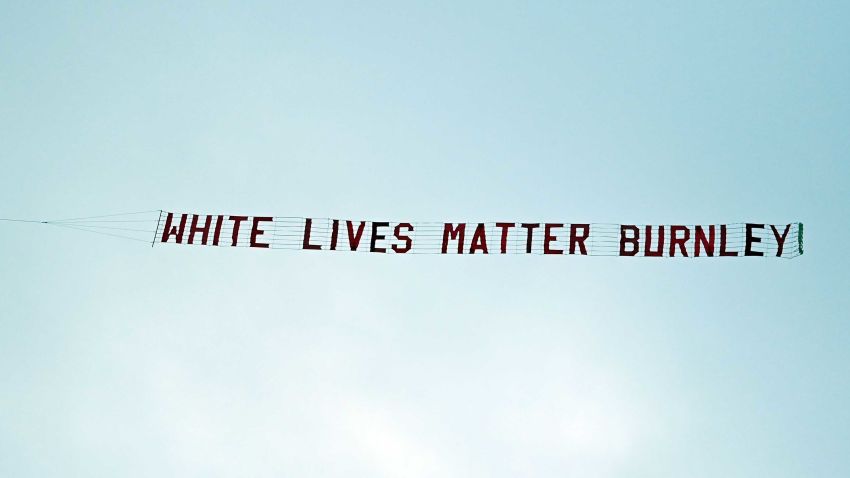 TOPSHOT - A banner reading 'White Lives Matter Burnley' is towed by a plane above the stadium during the English Premier League football match between Manchester City and Burnley at the Etihad Stadium in Manchester, north west England, on June 22, 2020. (Photo by Shaun Botterill / POOL / AFP) / RESTRICTED TO EDITORIAL USE. No use with unauthorized audio, video, data, fixture lists, club/league logos or 'live' services. Online in-match use limited to 120 images. An additional 40 images may be used in extra time. No video emulation. Social media in-match use limited to 120 images. An additional 40 images may be used in extra time. No use in betting publications, games or single club/league/player publications. / (Photo by SHAUN BOTTERILL/POOL/AFP via Getty Images)