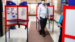 A polling worker walks among voting booths at a voting site inside Yonkers Middle/High School, Tuesday, June 23, 2020, in Yonkers, N.Y. (AP Photo/John Minchillo)