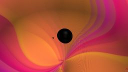 This image is a still from a video visualization of the coalescence of two black holes that inspiral and merge, emitting gravitational waves. One black hole is 9.2x more massive than the other and both objects are non-spinning. The high mass-ratio amplifies gravitational wave overtones in the emitted signal. The gravitational-wave signal produced is consistent with the observation made by the LIGO and Virgo gravitational-wave detectors on August 14th, 2019 (GW190814). 