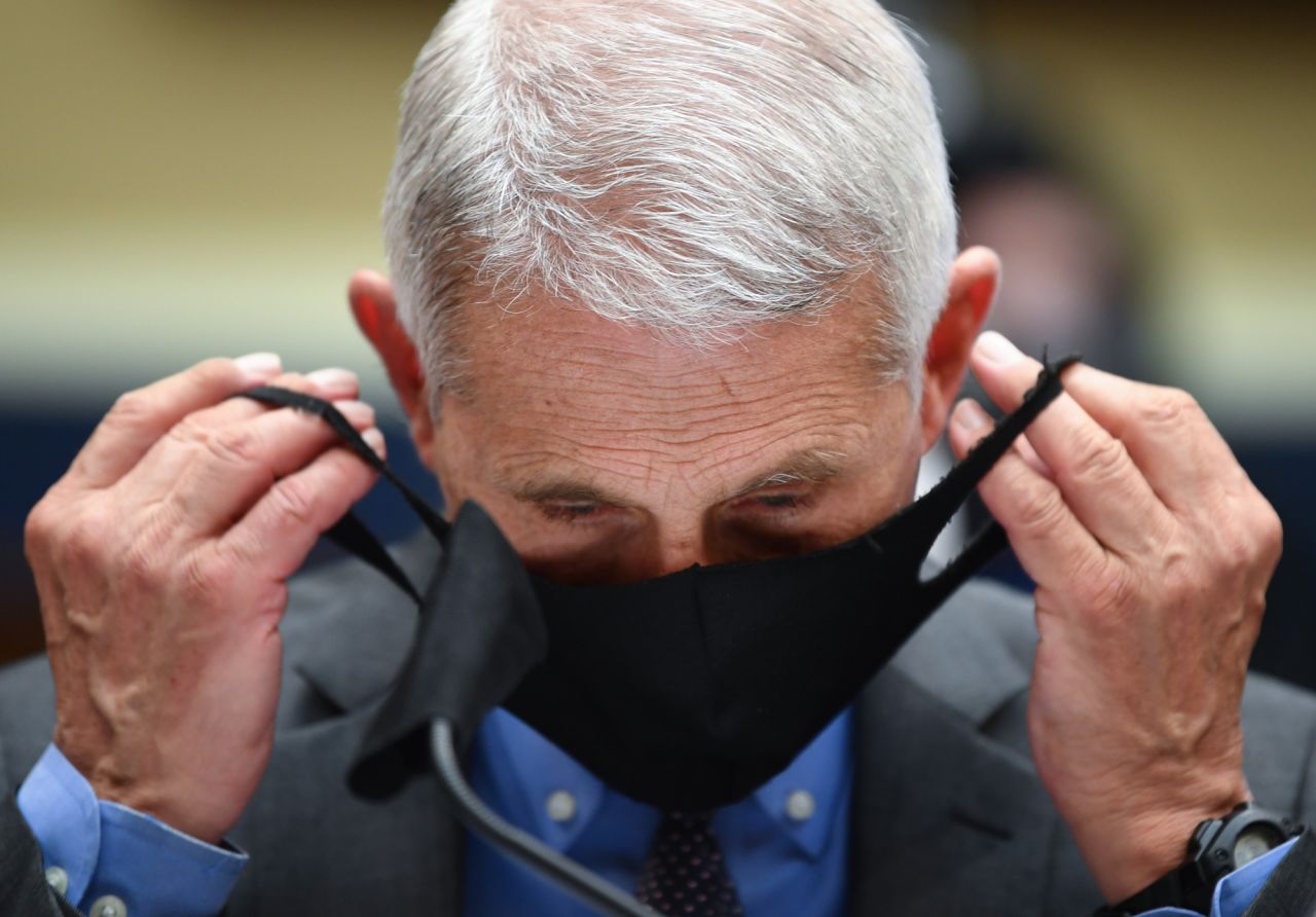 Dr. Anthony Fauci, director of the National Institute of Allergy and Infectious Diseases, takes off his face mask before testifying at a House committee hearing in Washington, DC, on Tuesday, June 23. <a href="https://www.cnn.com/2020/06/23/politics/fauci-redfield-coronavirus-oversight-hearing-house/index.html" target="_blank">The hearing</a> was about the Trump administration's response to the coronavirus pandemic.