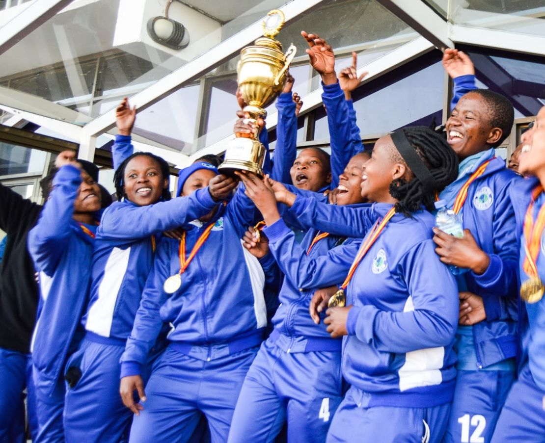 The women's team celebrate winning Kick4Life FC's first major trophy.