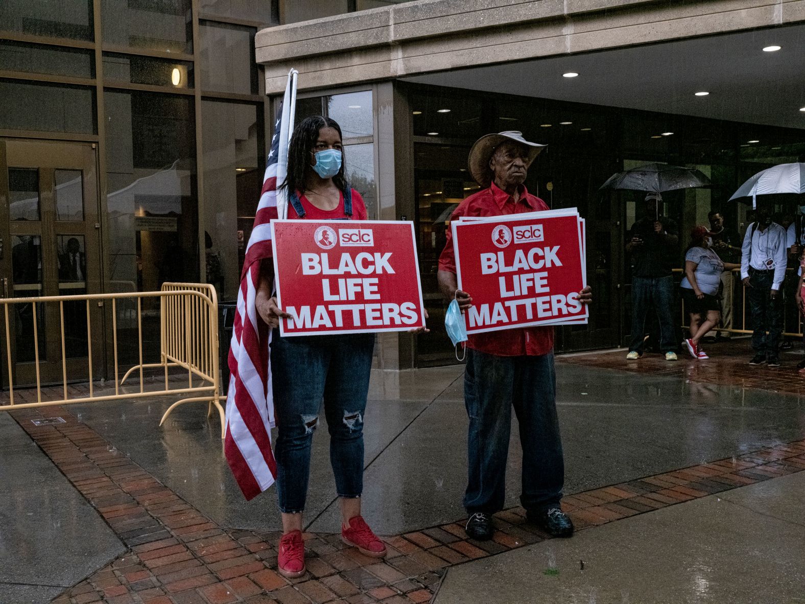 Protesters from the Southern Christian Leadership Conference stand in the rain on Monday.