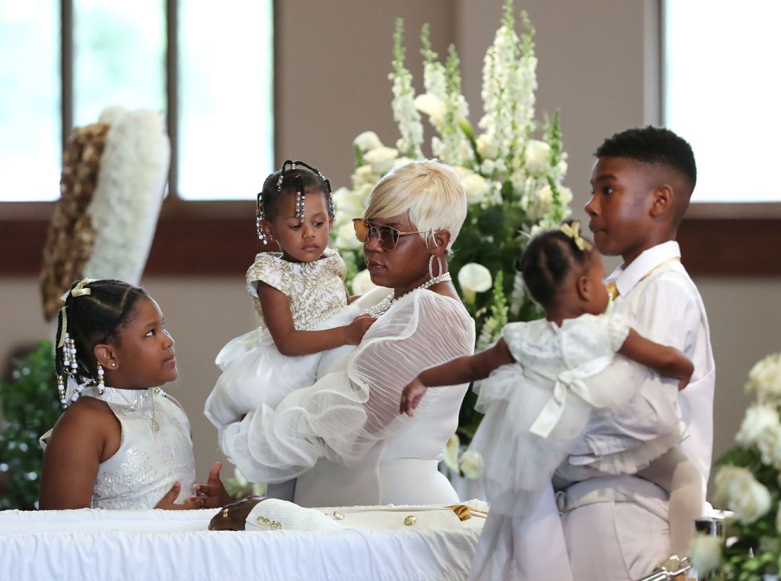 Tomika Miller, wife of Rayshard Brooks, holds their 2-year-old daughter Memory while pausing with her children at his funeral Monday at Ebenezer Baptist Church in Atlanta.