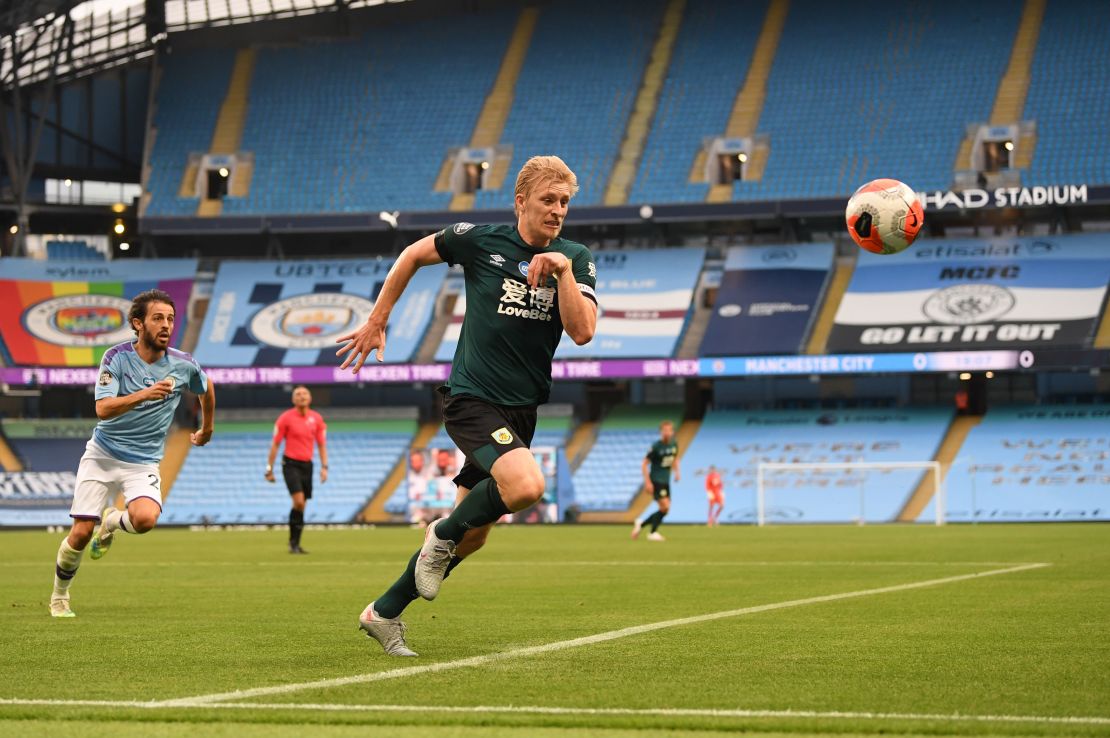 Ben Mee chases the ball during Burnley's 5-0 defeat by Manchester City. 