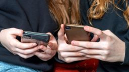 Teenagers use their cell phones