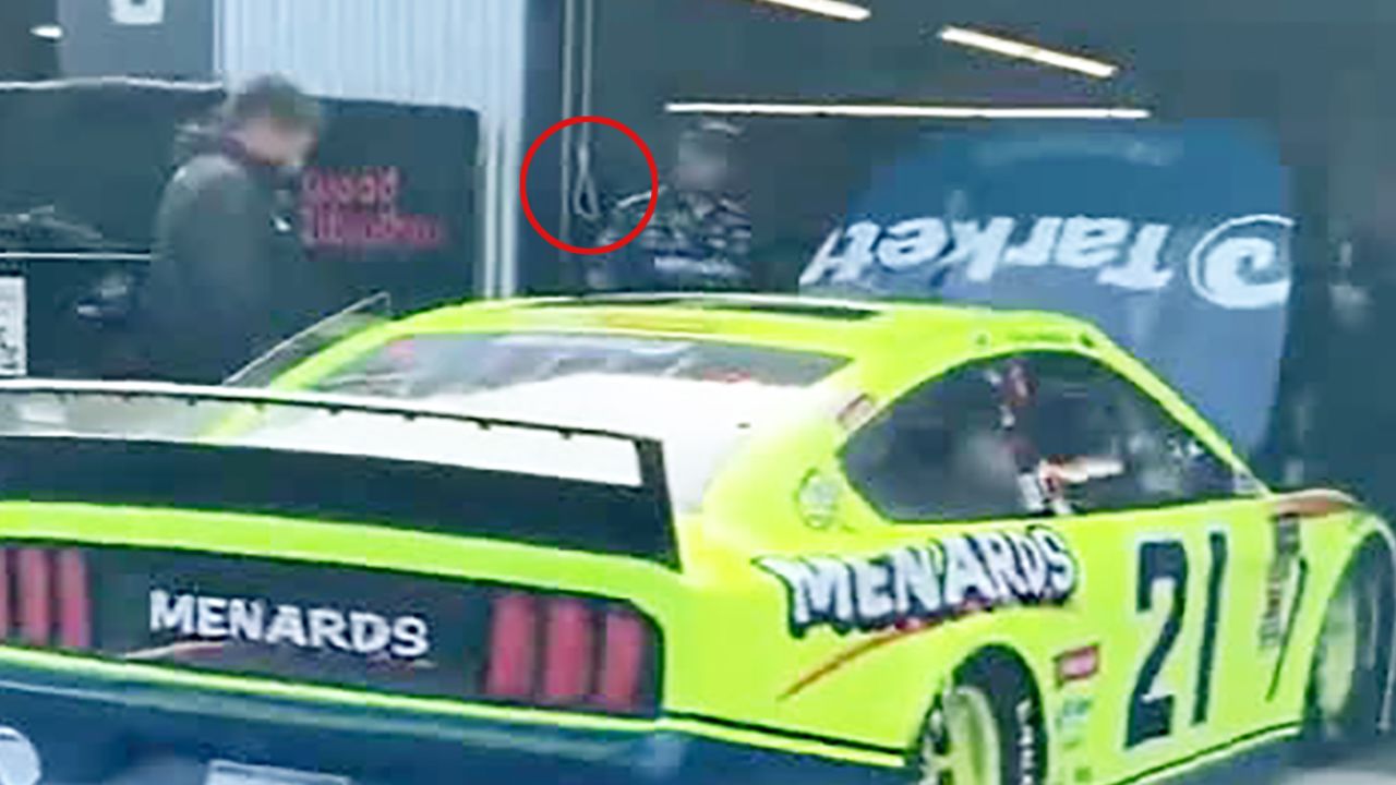 An image taken from a 2019  YouTube video shows a garage door rope fashioned into a noose in the stall used by Bubba Wallace's race team earlier this week at the Talladega Superspeedway in Alabama. A source with firsthand knowledge of the on-going NASCAR investigation told CNN that the noose in the 2019 video is the same noose Wallace's race team alerted NASCAR officials to. CNN circled the end of the rope to make it more visible.