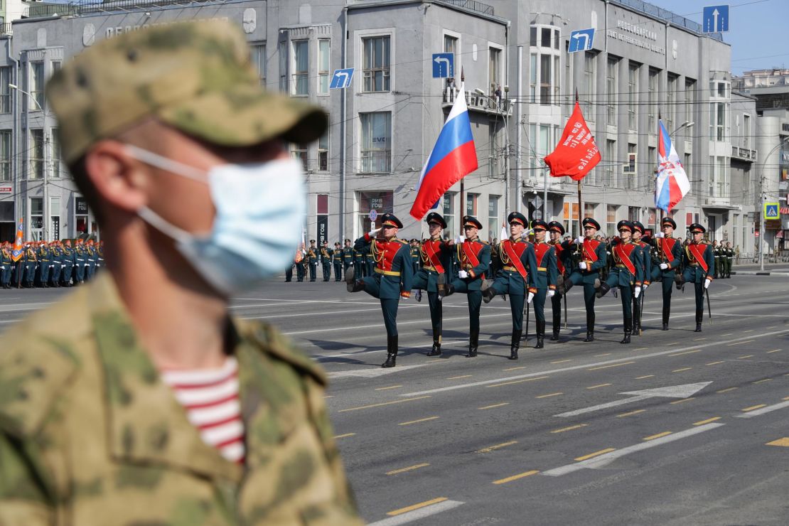 A Russian soldier wears a face mask in Lenin Square during the parade.