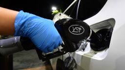 A person wearing a glove fills gas at a petrol station in Los Angeles, California on April 21, 2020, a day after oil prices dropped to below zero as the oil industry suffers steep falls in benchmark crudes due to the ongoing global coronavirus pandemic. - US oil prices surged on April 22 after falling below zero for the first time at the start of the week as markets drown in crude due to a virus-triggered collapse in demand. (Photo by Frederic J. Brown/AFP/Getty Images)