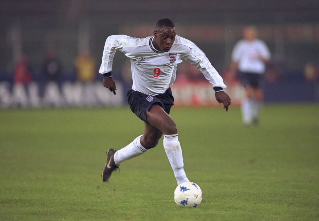 Heskey is pictured playing for England against Italy.