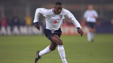 Heskey is pictured playing for England against Italy.