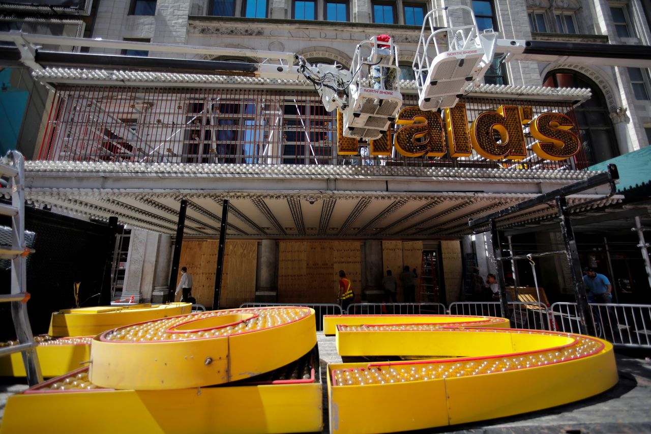 Workers remove a sign from the iconic McDonald's restaurant in New York's Times Square on Wednesday, June 24. <a href="https://www.cnn.com/2020/06/24/business/mcdonalds-times-square-closure/index.html" target="_blank">Its permanent closure</a> had been planned prior to the pandemic, the company said in a statement to CNN Business.