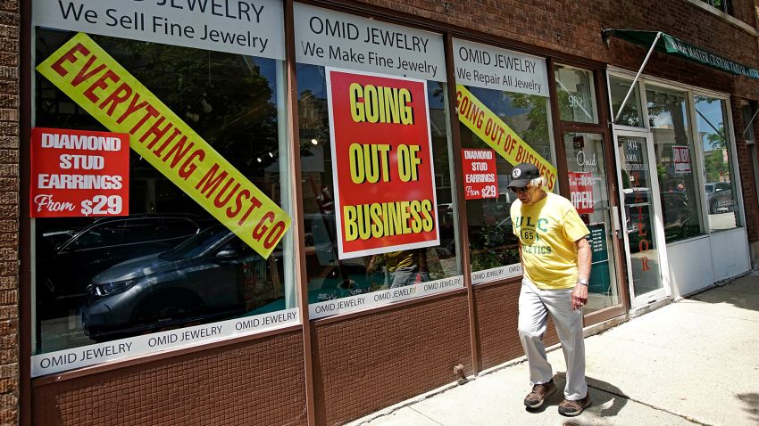 A man walks past a retail store that is going out of business due to the coronavirus pandemic in Winnetka, Ill., Tuesday, June 23, 2020. Illinois Gov. J.B Pritzker announced a package of state grant programs that will help support communities and businesses impacted by the COVID-19 pandemic and unrest in the area. (AP Photo/Nam Y. Huh)