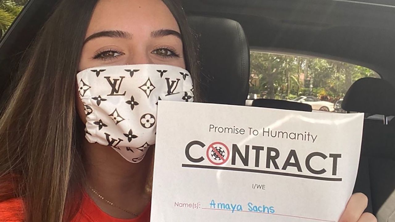 Amaya Sachs shows off her contract to practice safety measures against the coronavirus pandemic.
