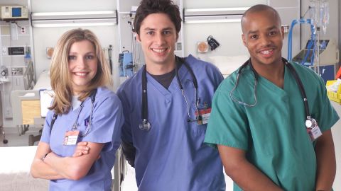 Actors Sarah Chalke, Zach Braff, and Donald Faison pose for a publicity photo for the television show "Scrubs."
