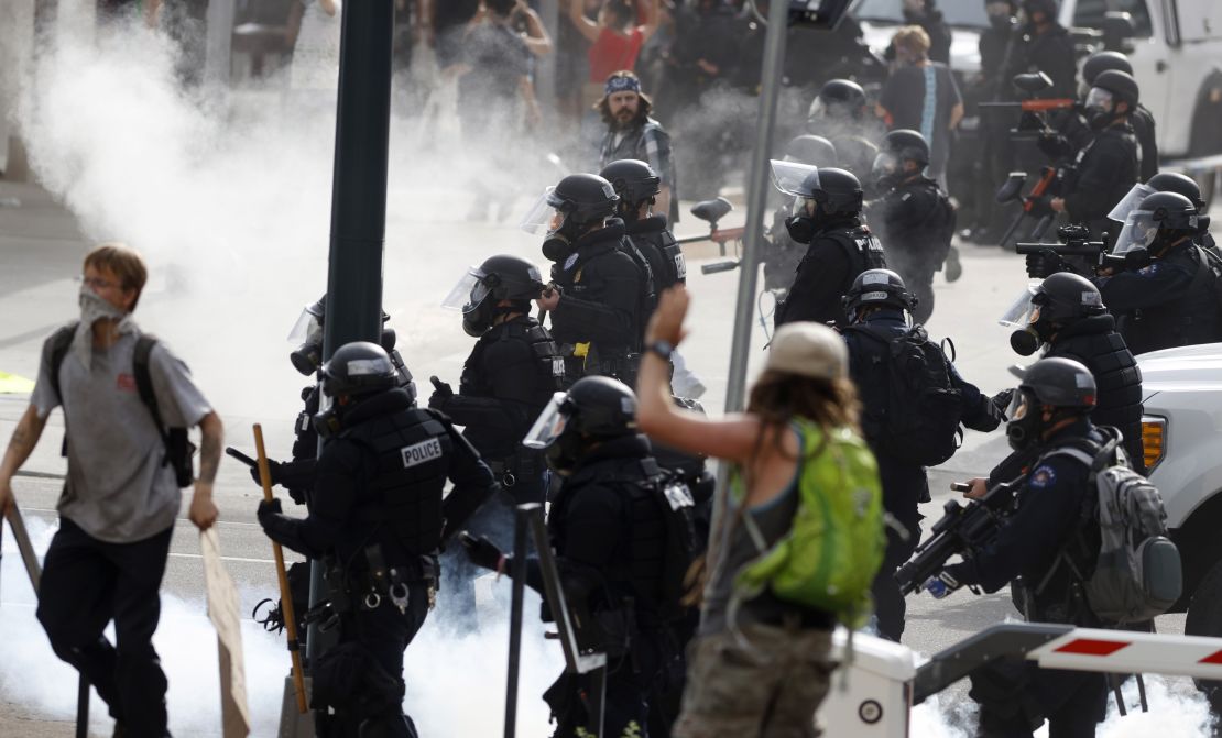 Denver Police advance after firing tear gas canisters during a protest outside the State Capitol over the death of George Floyd, on May 30.