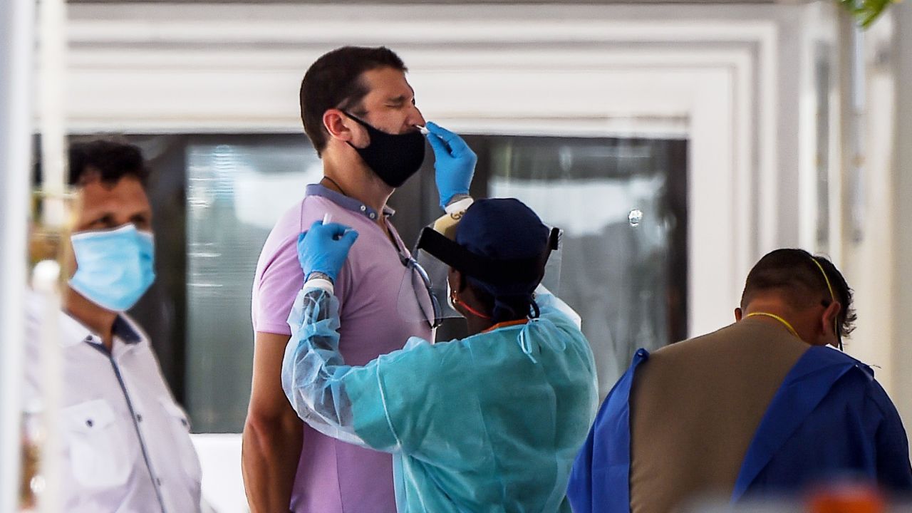 A healthcare worker takes a sample from a man at a COVID-19 testing site in Miami Beach, Florida on Wednesday, June 24, 2020.  Photo by Chandan Khanna/AFP/Getty Images