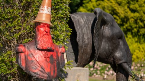 A statue in the grounds of Belgium's Royal Museum for Central Africa, featuring a bust of KIng Leopold II, has been covered in red paint and topped with a traffic cone "dunce's cap."