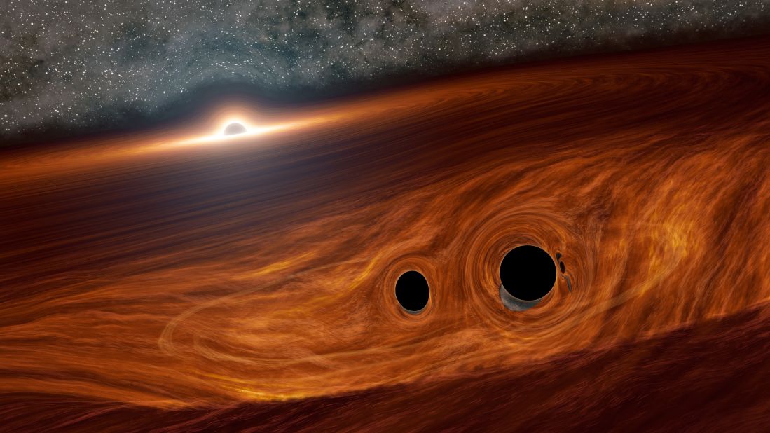 This is an artist's illustration of a supermassive black hole and its surrounding disk of gas. Inside this disk are two smaller black holes orbiting one another. Researchers identified a flare of light suspected to have come from one such binary pair soon after they merged into a larger black hole. 