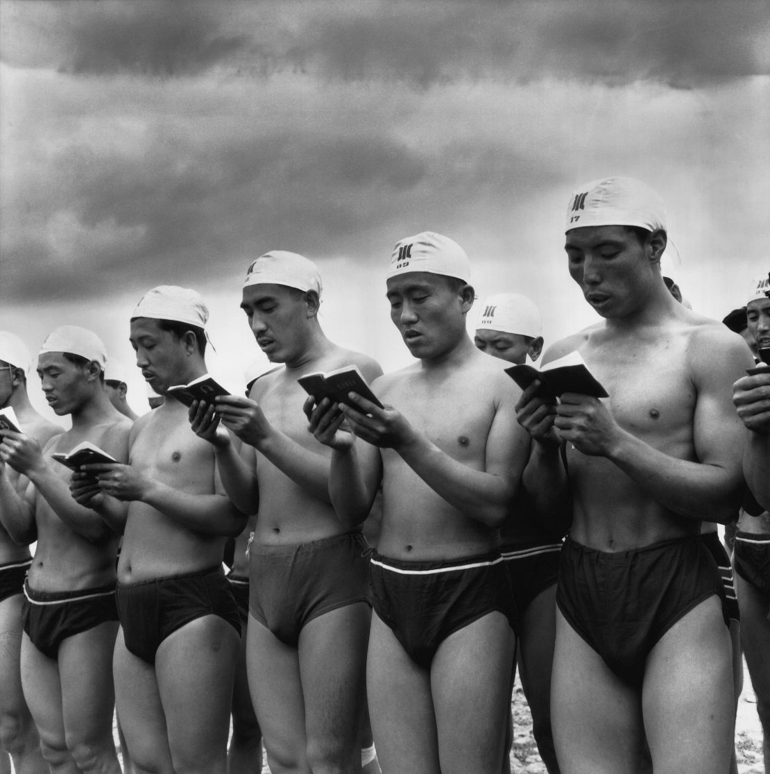 Swimmers read from Mao's "Little Red Book" as they prepare to commemorate the second anniversary of the leader's famous swim in the Yangtze.