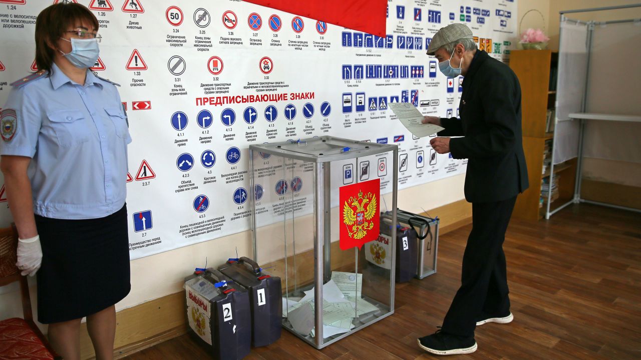 A man casts his vote at a ballot box in the village of Lugovoye.