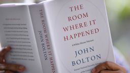 This illustration photo taken on June 23, 2020 in Glendale, California, shows a woman reading John Bolton's book "The Room Where it Happened" on the day of it's release in Los Angeles. - John Bolton's explosive tell-all account of his time as National Security Advisor is comparable to Edward Snowden's disclosure of state-backed mass surveillance of US citizens, Secretary of State Mike Pompeo said June 22, 2020.  Pompeo's comments come the night before the release of Bolton's book "The Room Where It Happened," which contains many damning allegations against President Donald Trump. (Photo by Chris DELMAS / AFP) (Photo by CHRIS DELMAS/AFP via Getty Images)