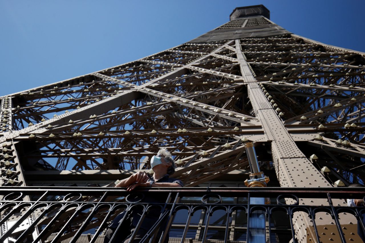 A visitor admires the view from the Eiffel Tower during its partial reopening in Paris on June 25. The elevators were still closed, but people were allowed to use the stairs.