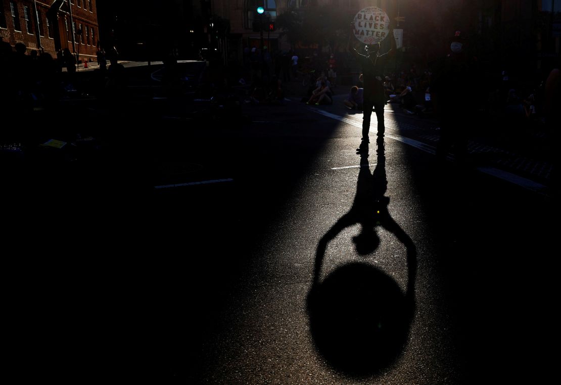 A man holds a Black Lives Matter sign during a protest against racial inequality on June 23, 2020, in Boston.