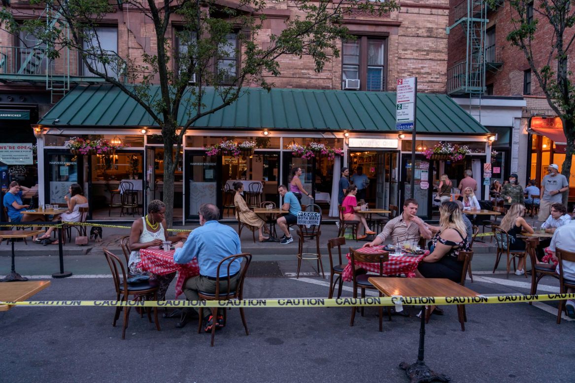 People eat outside the Harvest Kitchen restaurant in New York on Monday, June 22. The city, once the epicenter of the US coronavirus outbreak, <a href="https://www.cnn.com/2020/06/22/health/us-coronavirus-monday/index.html" target="_blank">has entered Phase Two of its reopening plan.</a> Phase Two allows for outdoor dining and the opening of barbershops and salons. Retail stores can open for in-person shopping at 50% capacity.