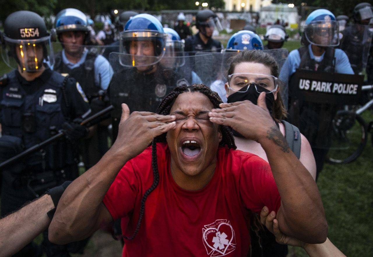 A woman reacts after being hit with pepper spray in Washington, DC, on Monday, June 22. Protesters near the White House had clashed with police <a href="https://www.cnn.com/2020/06/22/politics/white-house-secret-service-press/index.html" target="_blank">after trying to pull down a statue of former President Andrew Jackson.</a>
