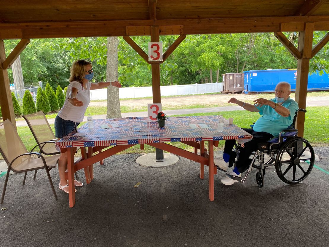 Cheryl Turgeon shares a socially distanced hug with her father in June. He survived, but the virus greatly weakened him, including impairing his circulation. "I hope to God we don't have to have his toes amputated," Turgeon said.