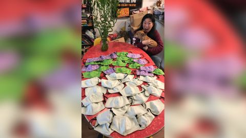 Kristina Wong of Los Angeles poses with her first batch of masks she made for a fire unit in New York.
