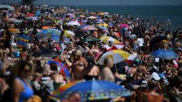 Beachgoers enjoy the sunshine at Southend on Sea on June 24.
