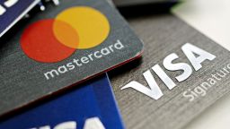 Visa Inc. and Mastercard Inc. credit cards are arranged for a photograph in Tiskilwa, Illinois, U.S., on Tuesday, Sept. 18, 2018. Visa and Mastercard agreed to pay as much as $6.2 billion to end a long-running price-fixing case brought by merchants over card fees, the largest-ever class action settlement of an antitrust case. Photographer: Daniel Acker/Bloomberg via Getty Images