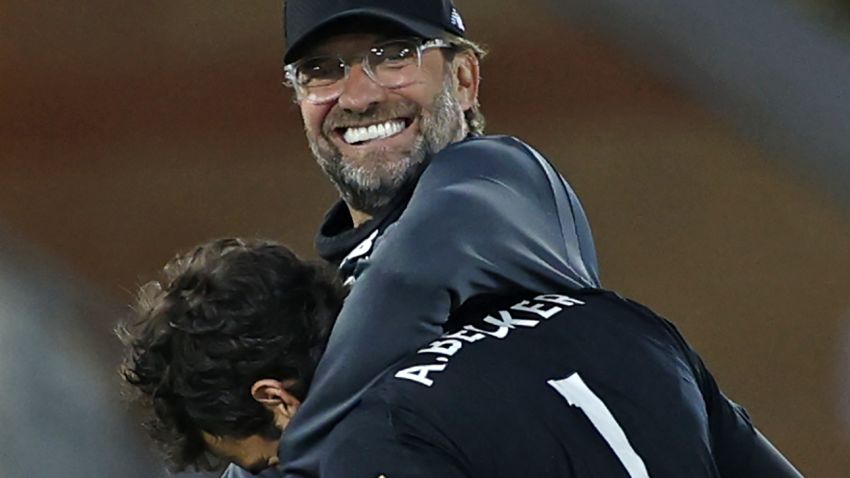 Liverpool's German manager Jurgen Klopp (L) huggs Liverpool's Brazilian goalkeeper Alisson Becker after the English Premier League football match between Liverpool and Crystal Palace at Anfield in Liverpool, north west England on June 24, 2020. - Liverpool won the match 4-0. (Photo by PHIL NOBLE / POOL / AFP) / RESTRICTED TO EDITORIAL USE. No use with unauthorized audio, video, data, fixture lists, club/league logos or 'live' services. Online in-match use limited to 120 images. An additional 40 images may be used in extra time. No video emulation. Social media in-match use limited to 120 images. An additional 40 images may be used in extra time. No use in betting publications, games or single club/league/player publications. /  (Photo by PHIL NOBLE/POOL/AFP via Getty Images)