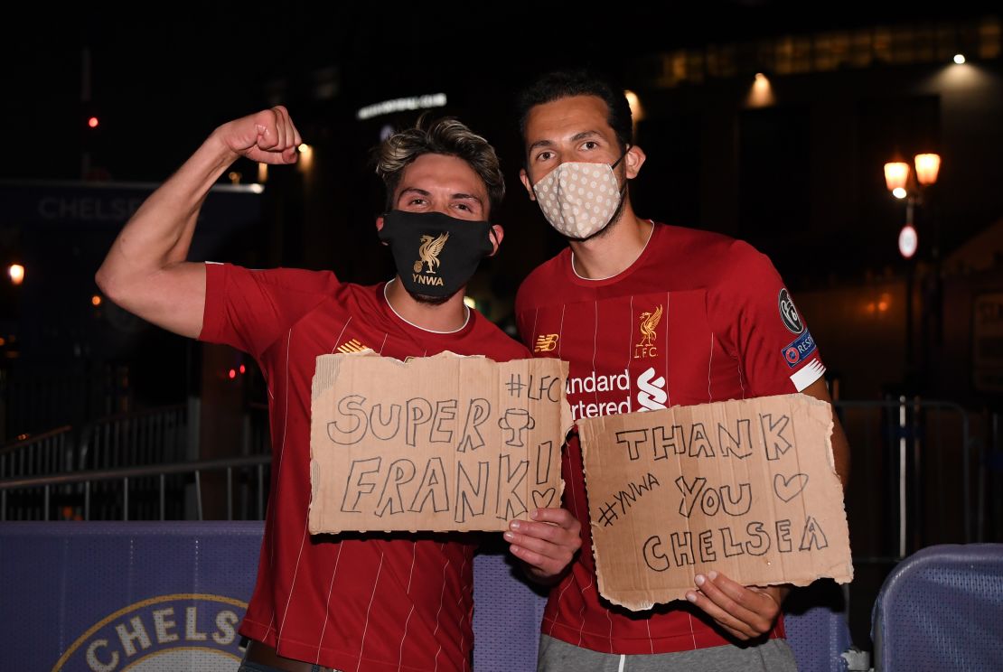 Liverpool fans celebrate their team winning the Premier League title outside Anfield. 