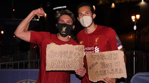 Liverpool fans celebrate their team winning the Premier League title outside Anfield. 