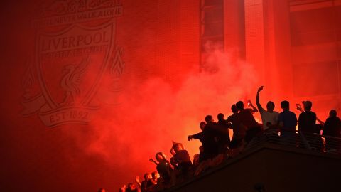 Fans outside Anfield, celebrating Liverpool's historic win. 