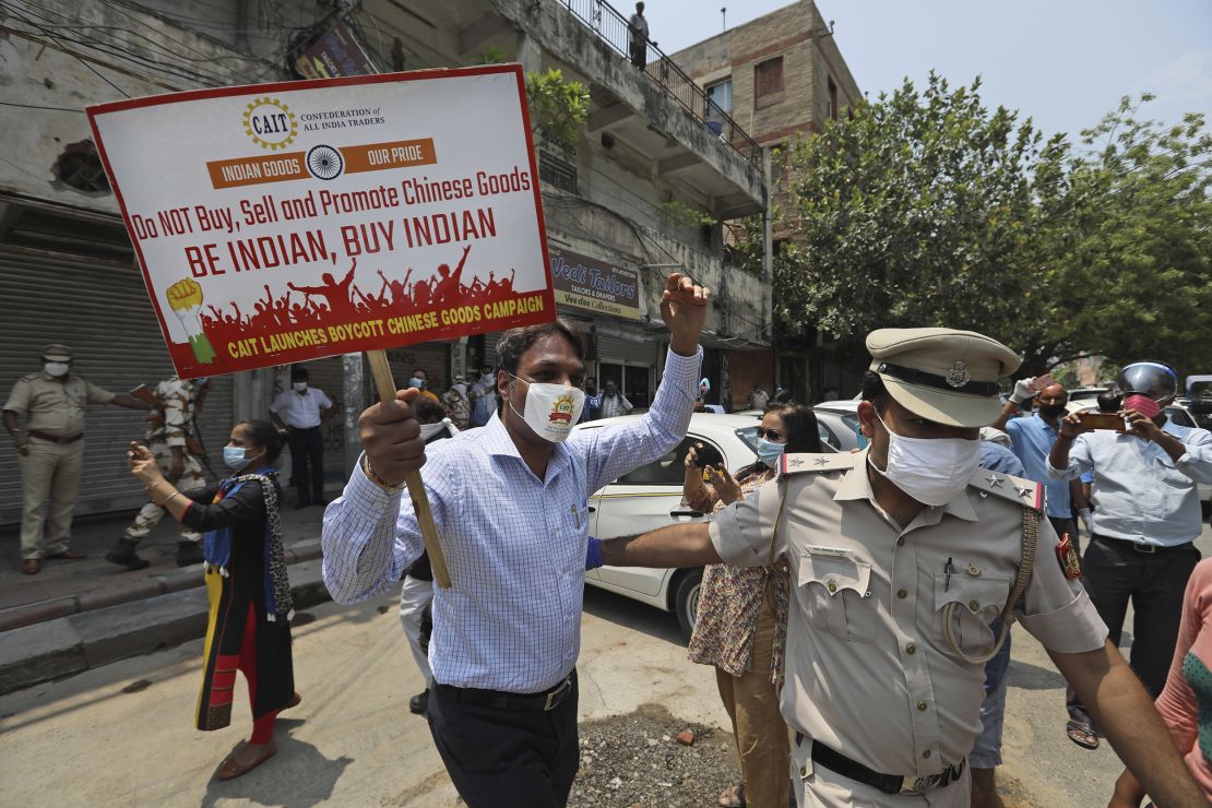 Police detaining an Indian trader who was burning Chinese products during a protest in New Delhi on Monday.