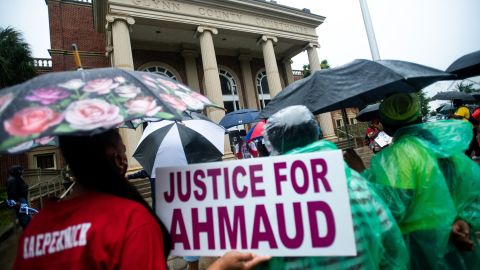 Demonstrators gather at the Glynn County courthouse during a June court appearance by Gregory and Travis McMichael, two suspects in the fatal shooting of Ahmaud Arbery.