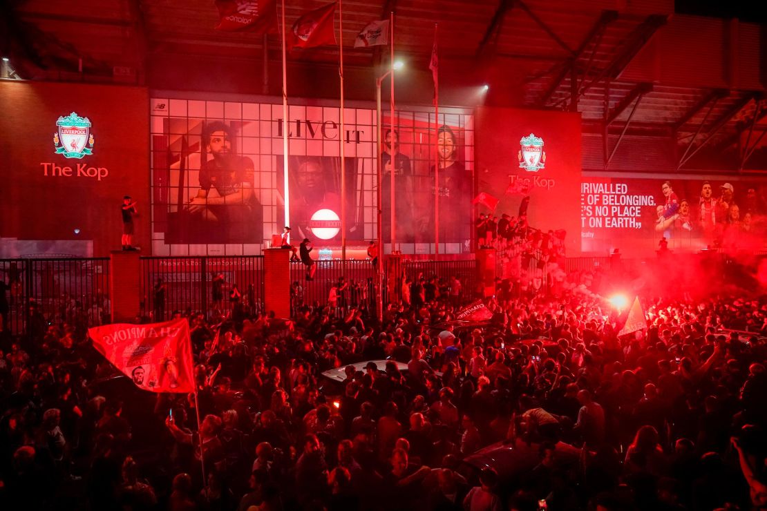 Liverpool fans celebrate at Anfield Stadium after wining the Premier League title.