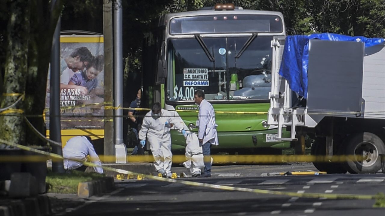 Experts work at the crime scene after Mexico City's Public Security Secretary Omar Garcia Harfuch was wounded in an attack in Mexico City on Friday, June 26, 2020