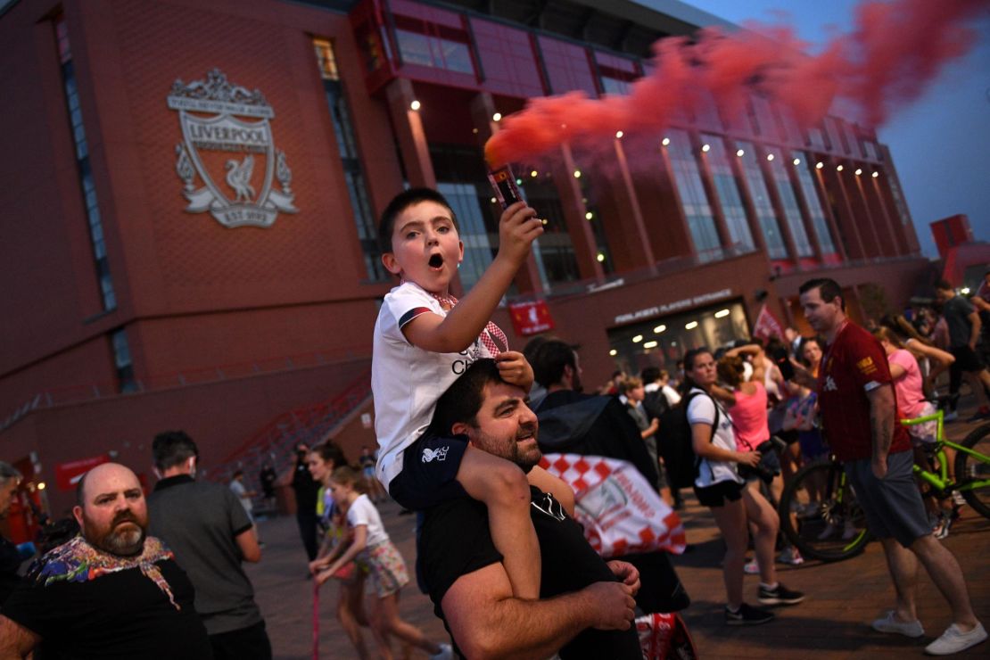 Fans celebrated Liverpool winning the title outside Anfield stadium.