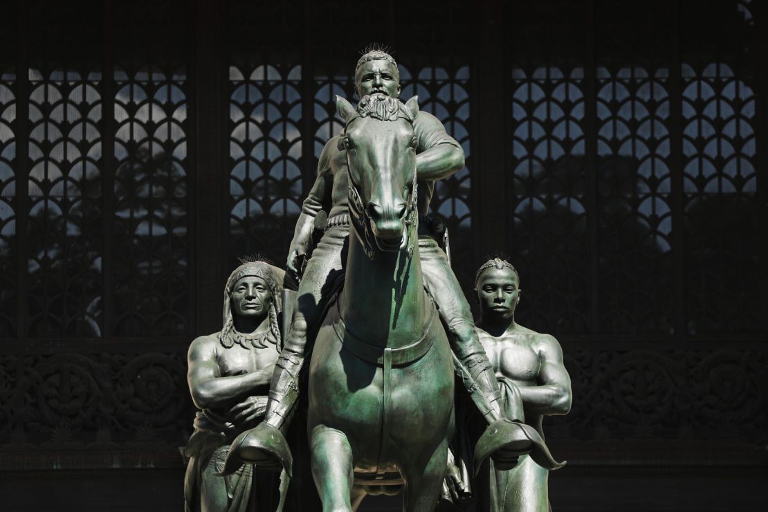 The controversial statue of former President Theodore Roosevelt outside of the Museum of Natural History, featuring a Black man and a Indigenous man at his sides