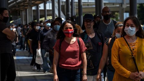Commuters line up to cross to the United States at the San Ysidro crossing port in Tijuana on June 16, 2020.