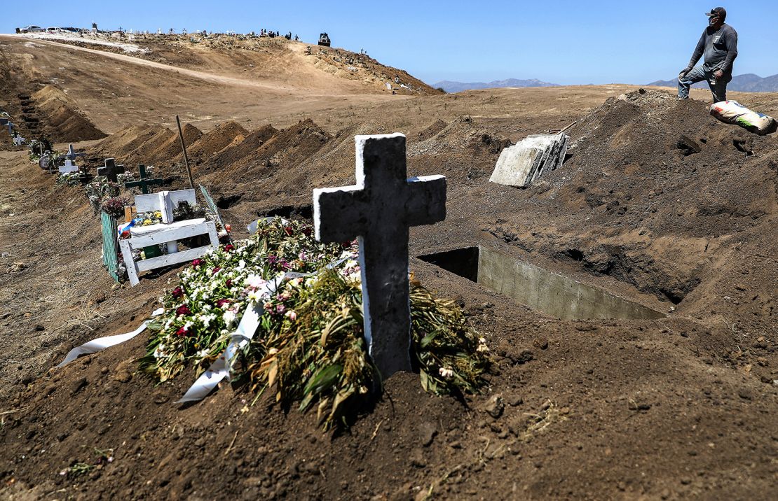 A cemetery worker takes a break from digging new graves at Tijuana Municipal Cemetery 13 amid the COVID-19 pandemic on May 11, 2020 in Tijuana, Mexico. 
