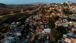 Aerial view of Colonia Libertad neighbourhood in Tijuana, Baja California State, Mexico, next to the US border fence (left), taken on May 21, 2020, during the COVID-19 coronavirus pandemic. - Overcrowded neighbourhoods and a big population within poverty levels are a big challenge Latin American countries are facing during this global pandemic. (Photo by  ARIAS / AFP) (Photo by GUILLERMO ARIAS/AFP via Getty Images)