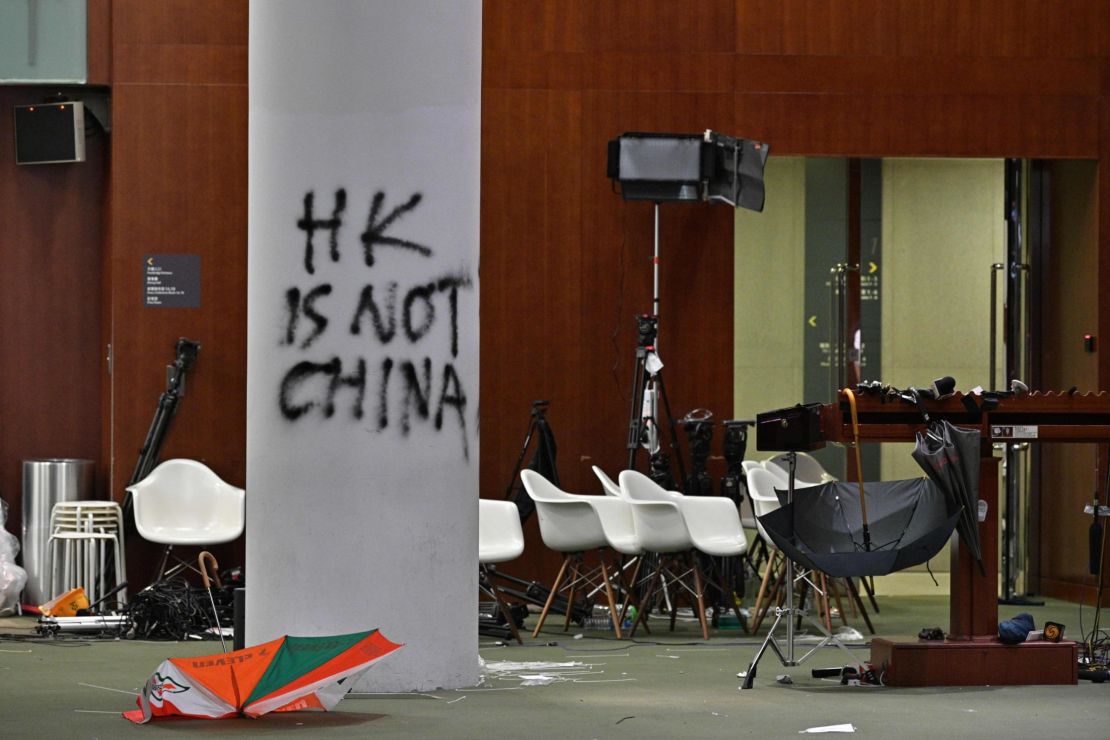 Graffiti and umbrellas are seen outside the main chamber of the Legislative Council during a media tour in Hong Kong on July 3, 2019, two days after protesters broke into the complex.