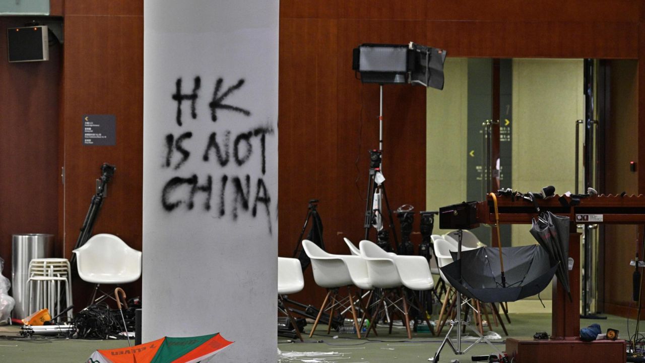 Graffiti and umbrellas are seen outside the main chamber of the Legislative Council during a media tour in Hong Kong on July 3, 2019, two days after protesters broke into the complex.